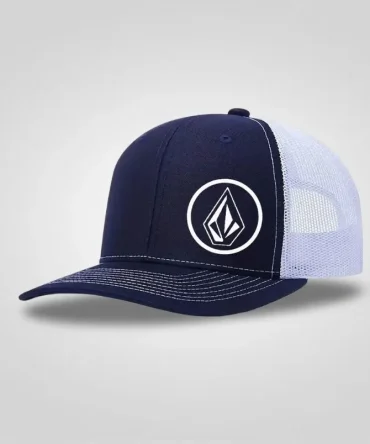 Navy blue and white mesh trucker cap with a white Volcom stone logo embroidered on the front. Adjustable and breathable.