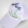 A white baseball cap features a hand-painted scene of two black and gold goldfish swimming above green aquatic plants. This design is ideal for sun protection.