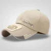 A light beige baseball cap with a small, white, battery-operated fan attached to the brim, featuring "FASHION LINE CAP" text and reflective accents.
