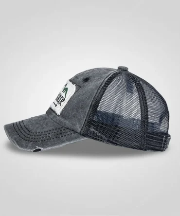 Side profile of a distressed charcoal gray trucker cap with "EXPLORER" patch and black mesh back.