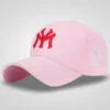 Black baseball cap with 3D gold embroidered "NY" logo and a circular gold and black emblem on the side, featuring gold trim on the brim.
