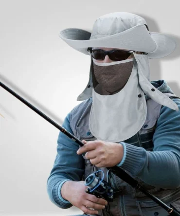 Man fishing wearing grey wide-brim sun hat with face and neck flap, sunglasses, and fishing vest.