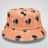 Orange bucket hat with black and white cartoon zebra stripe monster pattern.